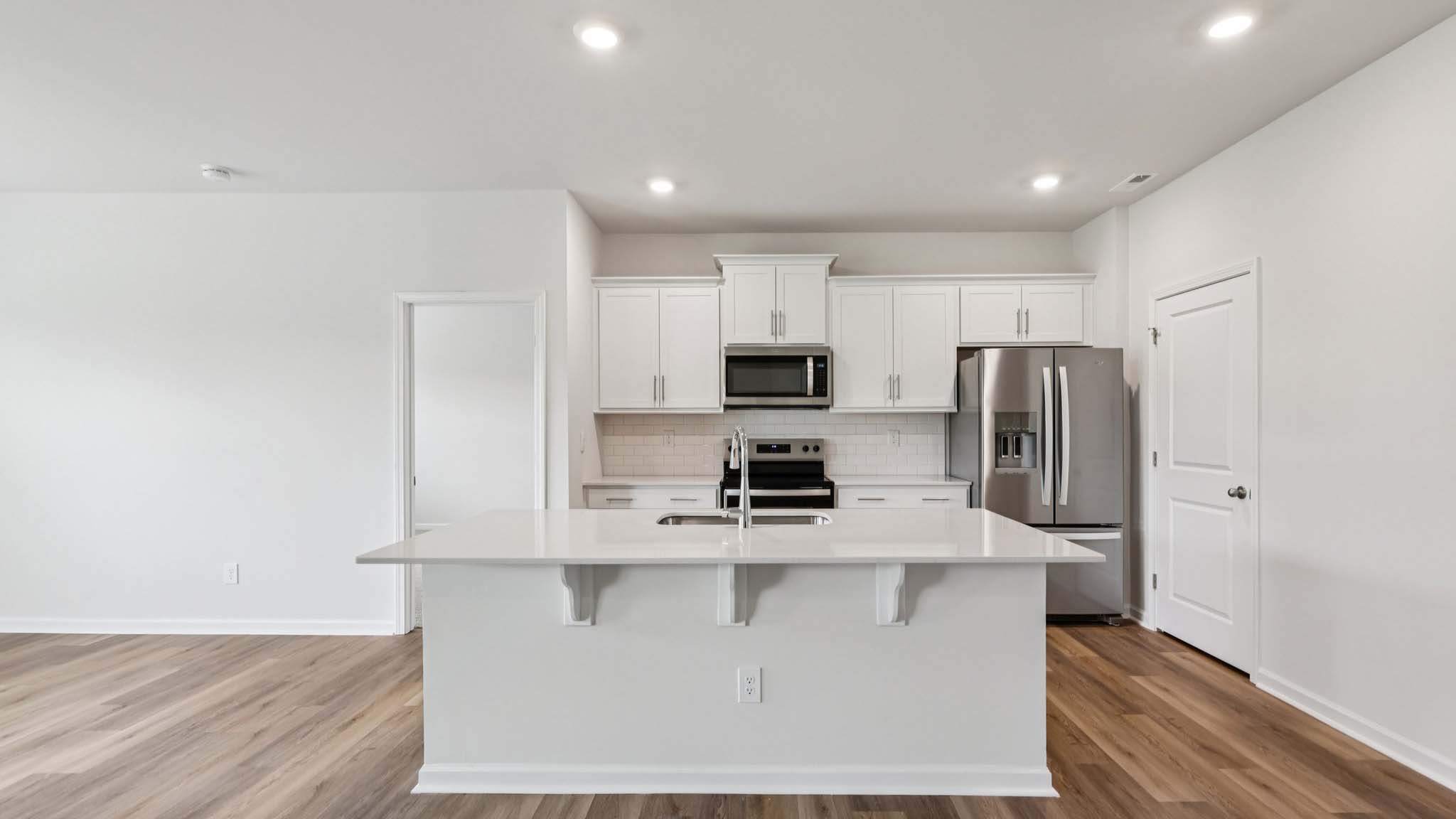 kitchen and island with stainless steel appliances