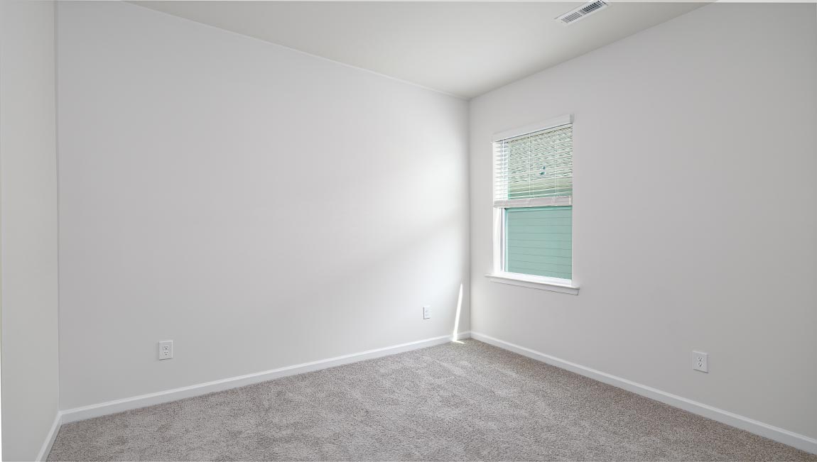 Carpeted bedroom with windows