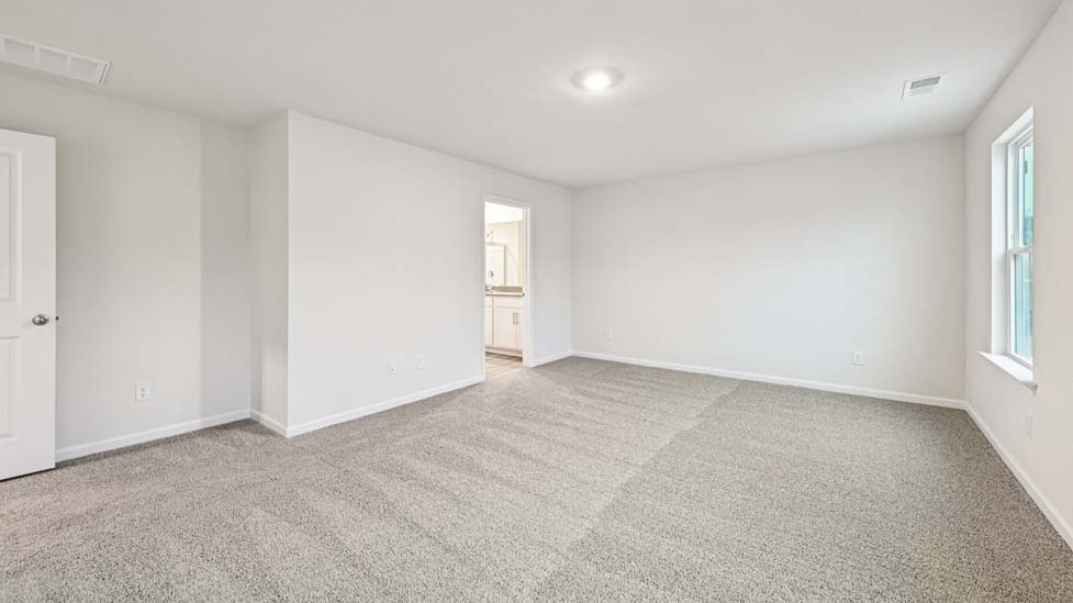Carpeted bedroom with large window