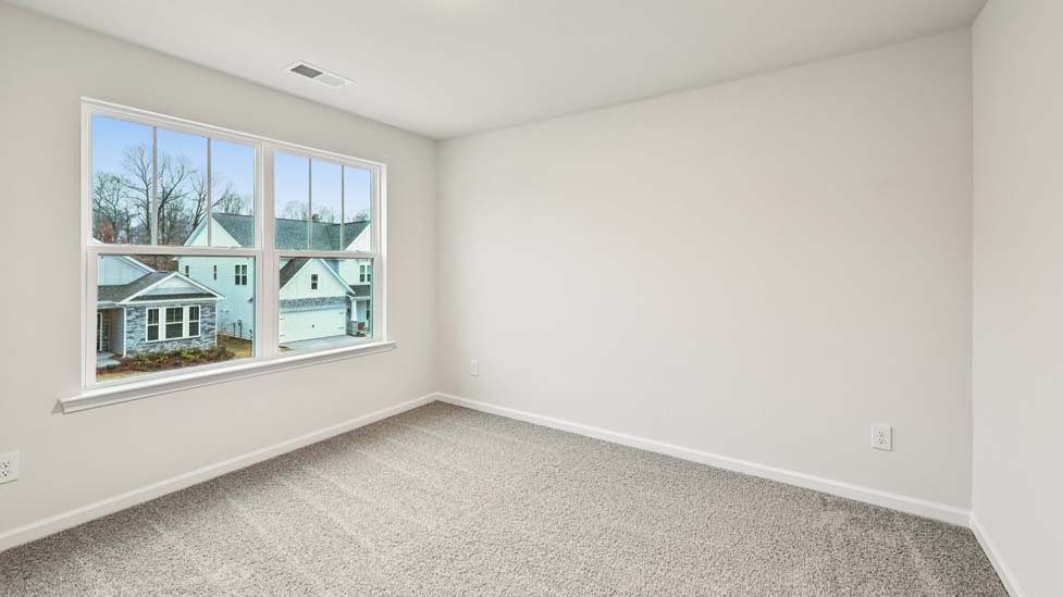Carpeted bedroom with large window
