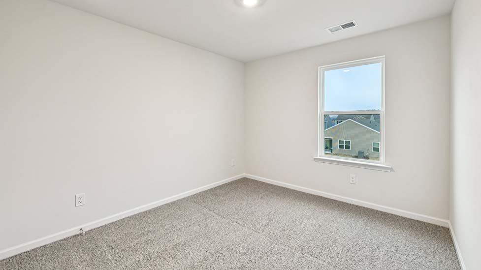 Carpeted bedroom with large window