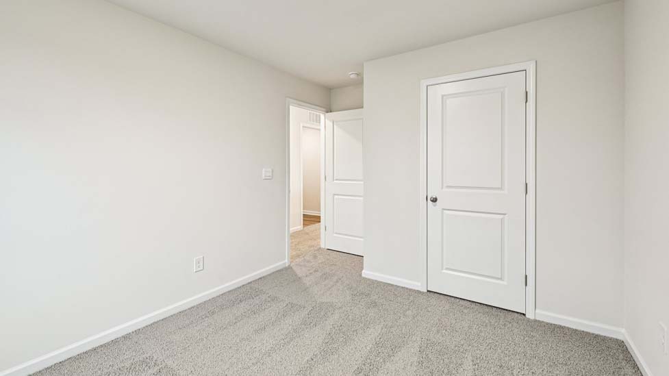 Carpeted bedroom with large window