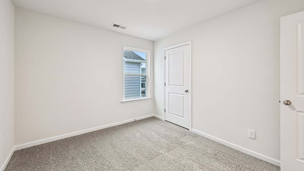 Carpeted bedroom with large window