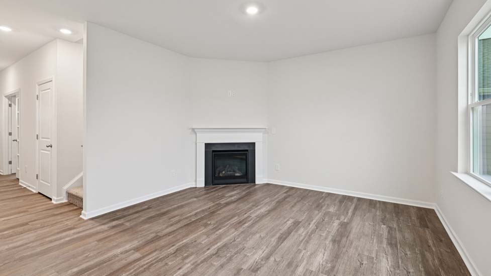 living room with vinyl flooring, electric fireplace and large window