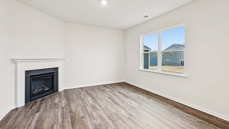 living room with vinyl flooring, electric fireplace and large window