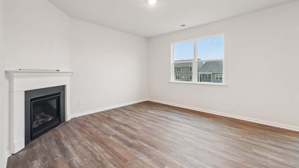 living room with vinyl flooring, electric fireplace and large window