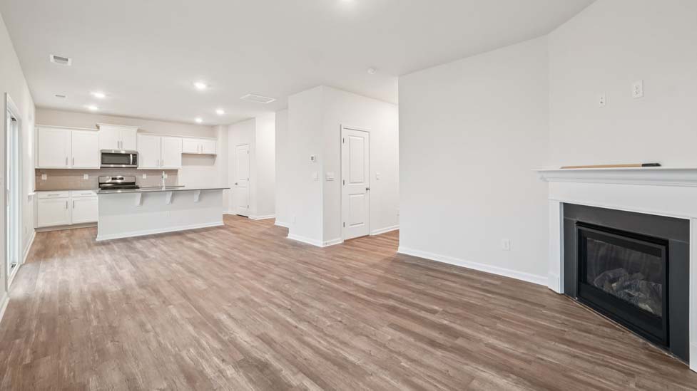 living room with vinyl flooring, electric fireplace and large window