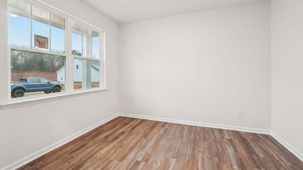 Flex space with hard wood flooring, large window and french doors