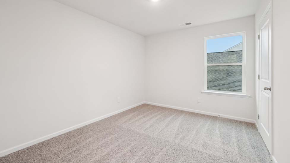 Carpeted bedroom with large window