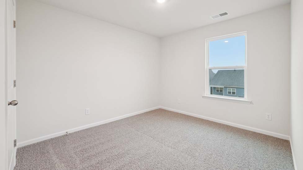 Carpeted bedroom with large window