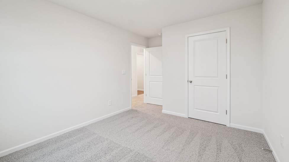 Carpeted bedroom with large window