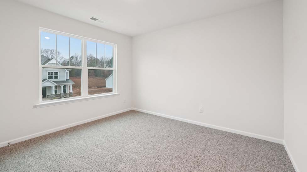 Carpeted bedroom with large window