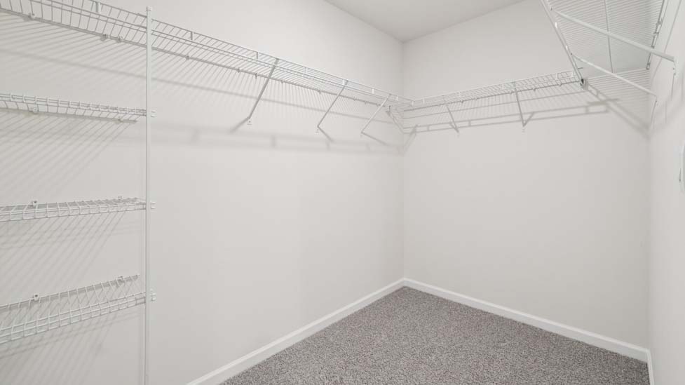 Primary bedroom walk in closet