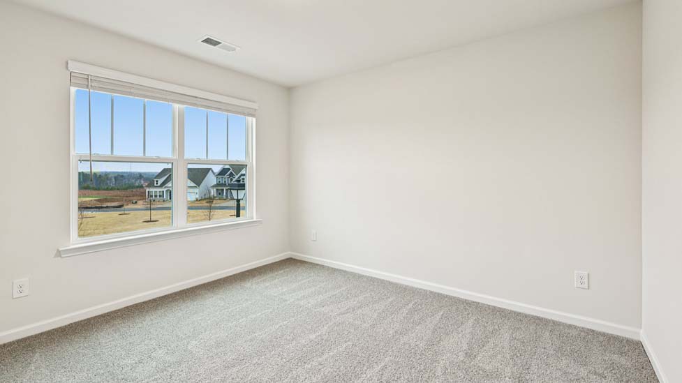 Carpeted bedroom with large window