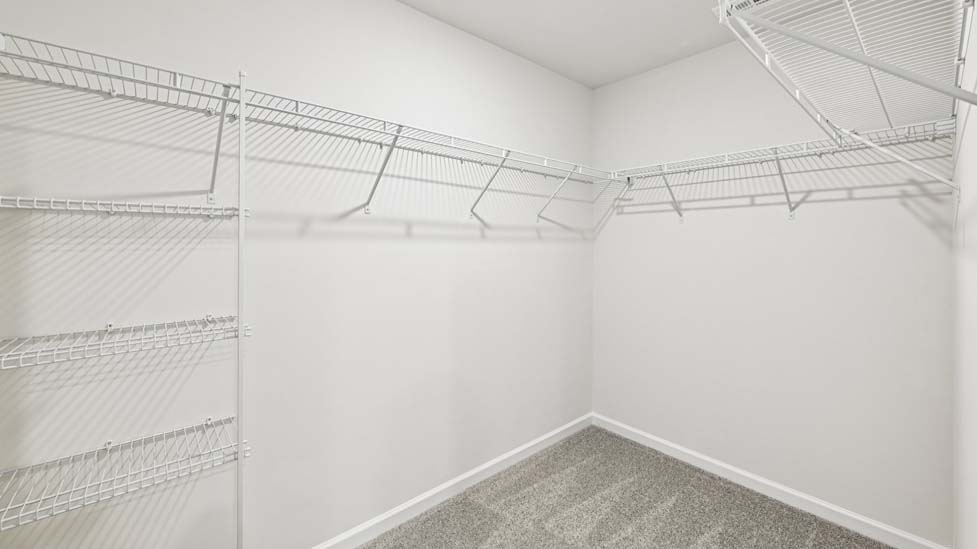 Primary bedroom walk in closet