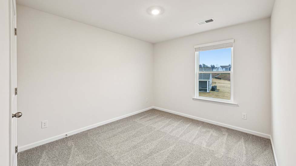 Carpeted bedroom with large window