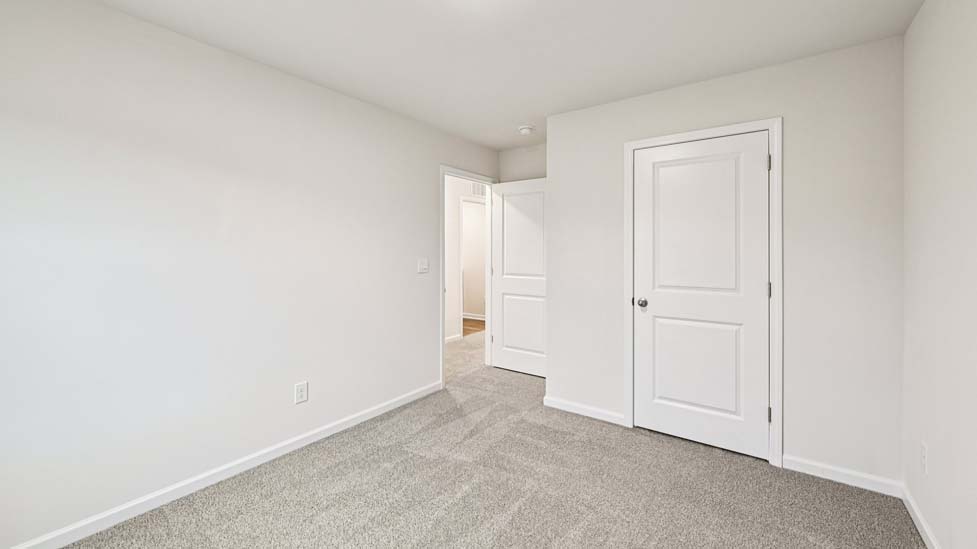 Carpeted bedroom with large window