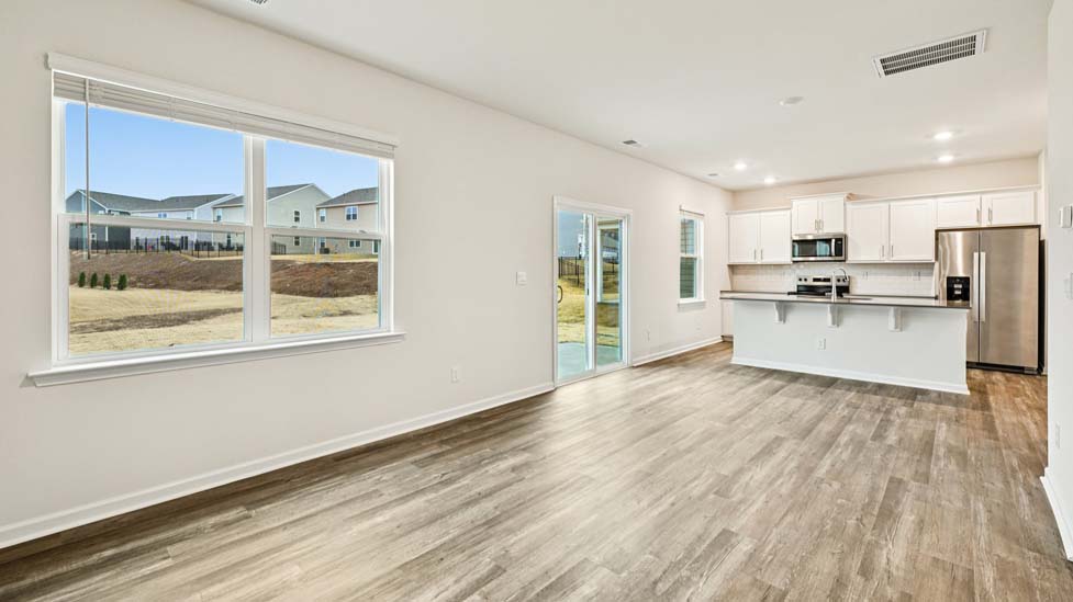 living room with vinyl flooring, electric fireplace and large window