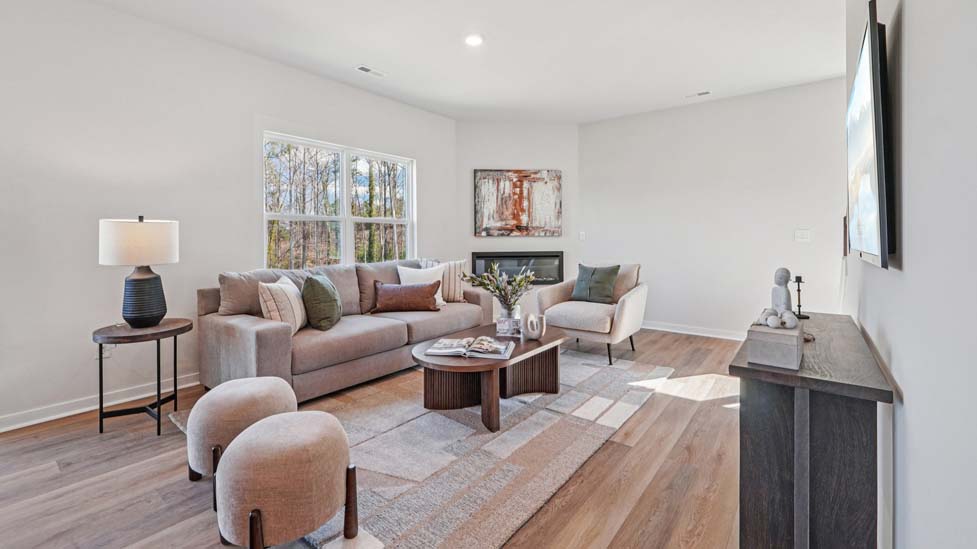 living room with vinyl floors, electric fireplace and large window