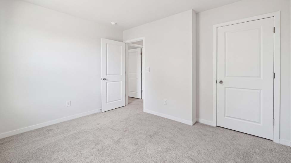carpeted bedroom with large window