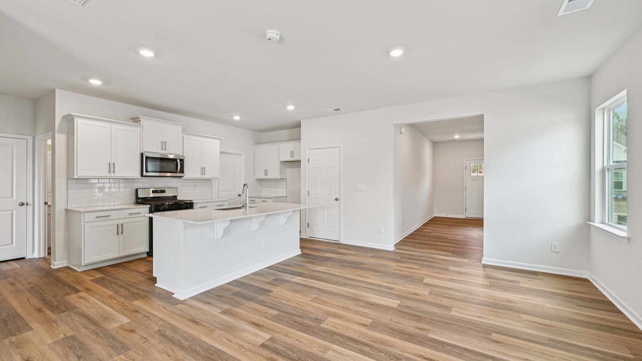 Kitchen and island with stainless steel appliances