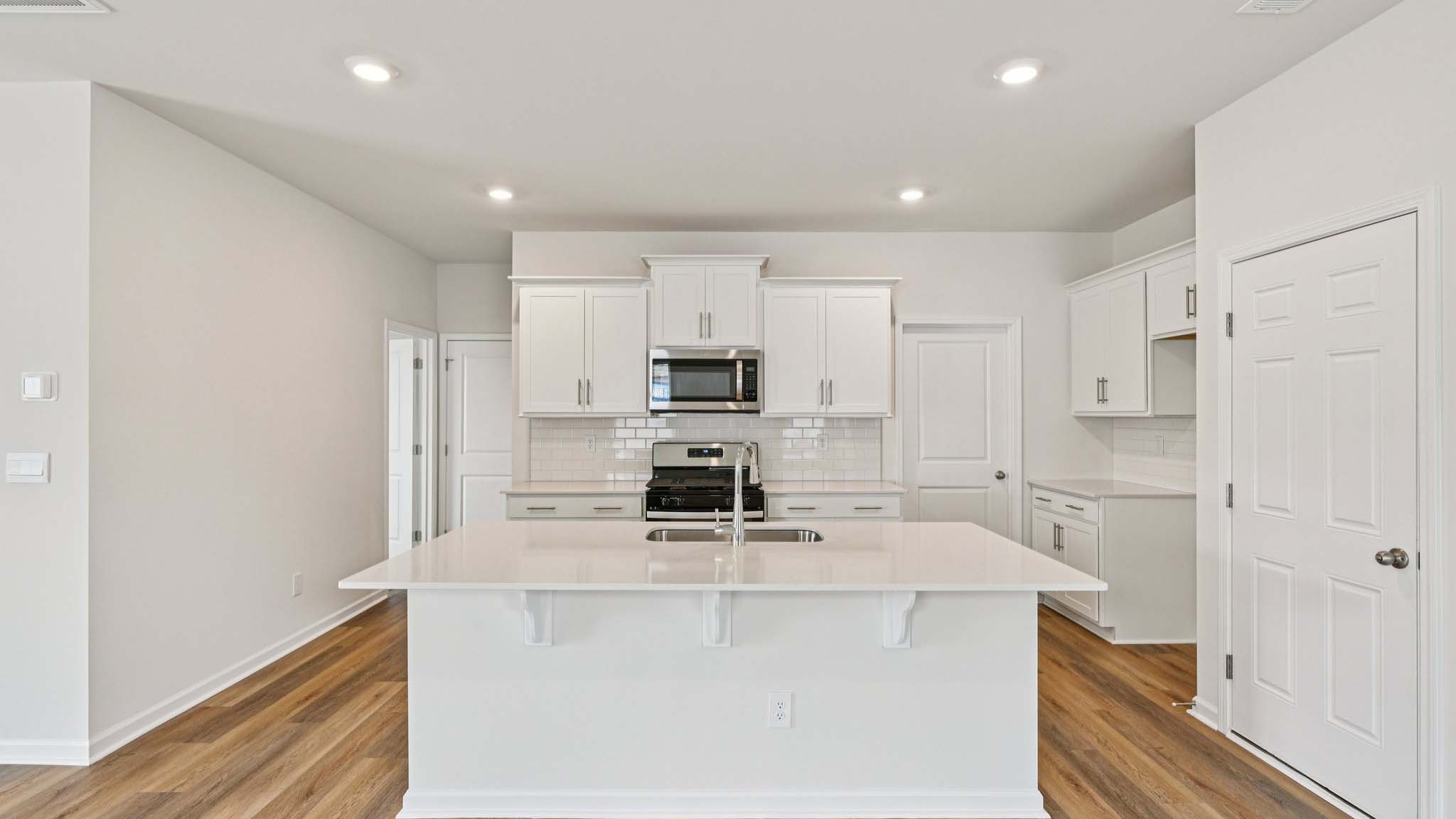 Kitchen and island with stainless steel appliances