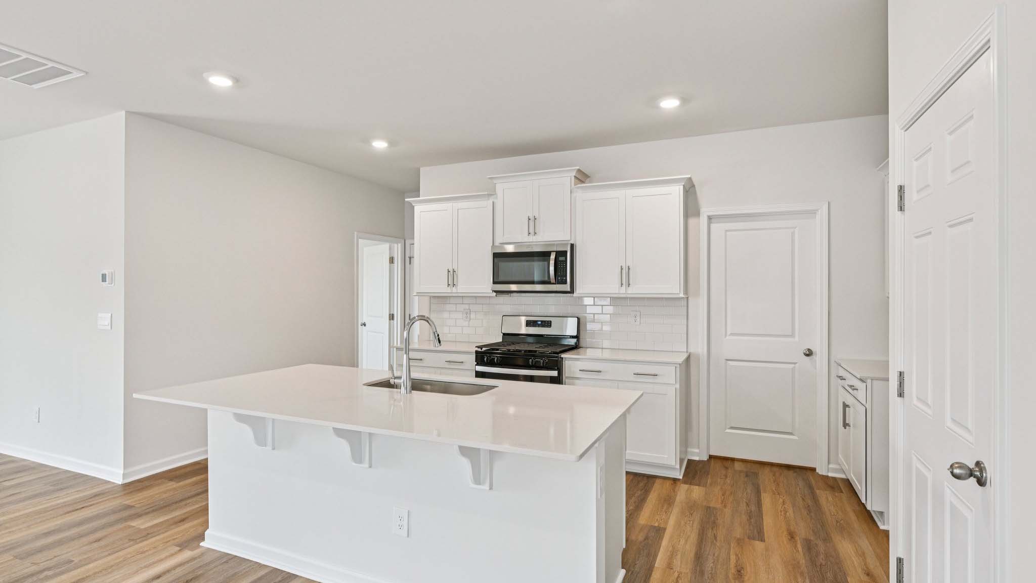 Kitchen and island with stainless steel appliances