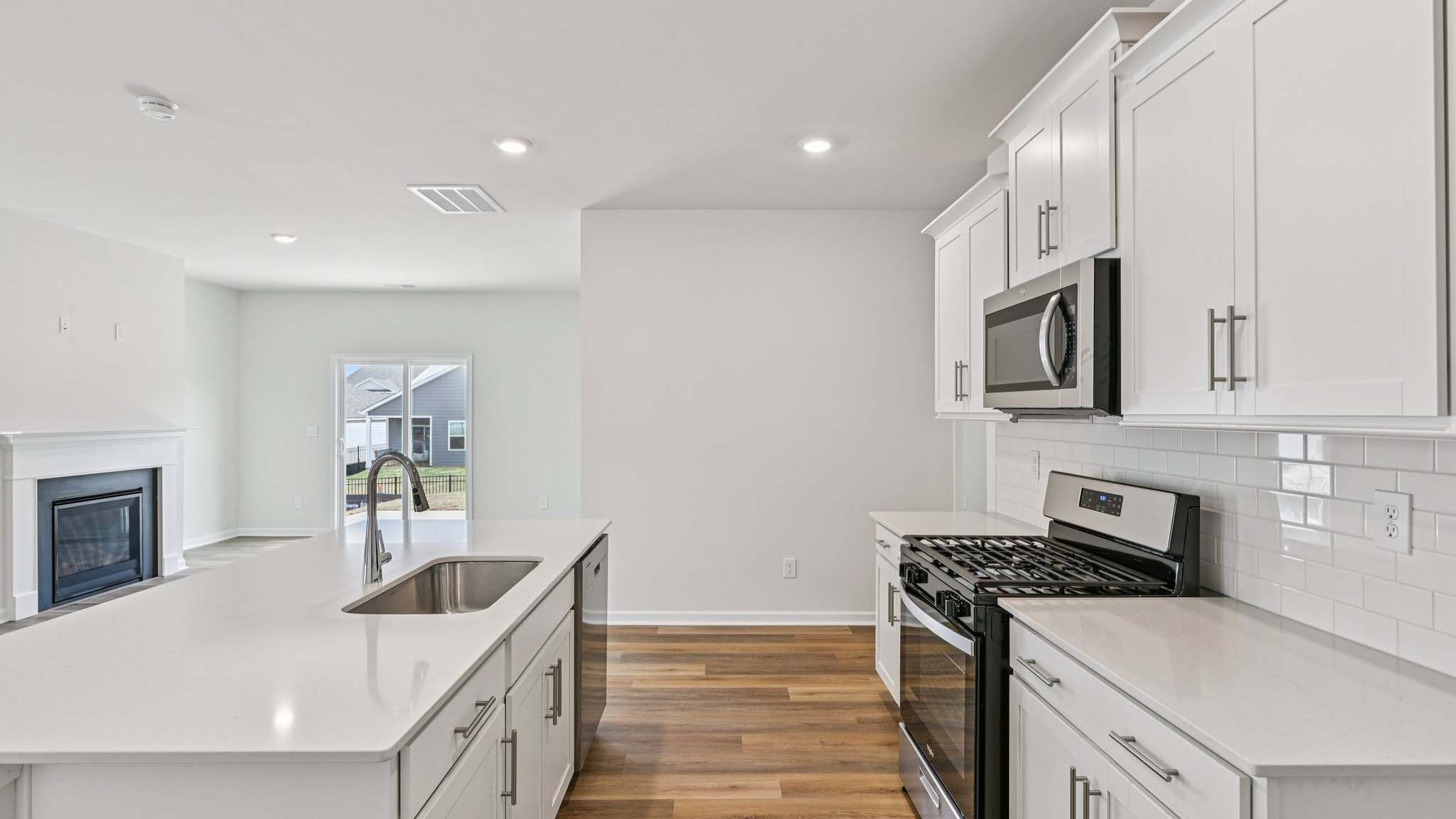 Kitchen and island with stainless steel appliances