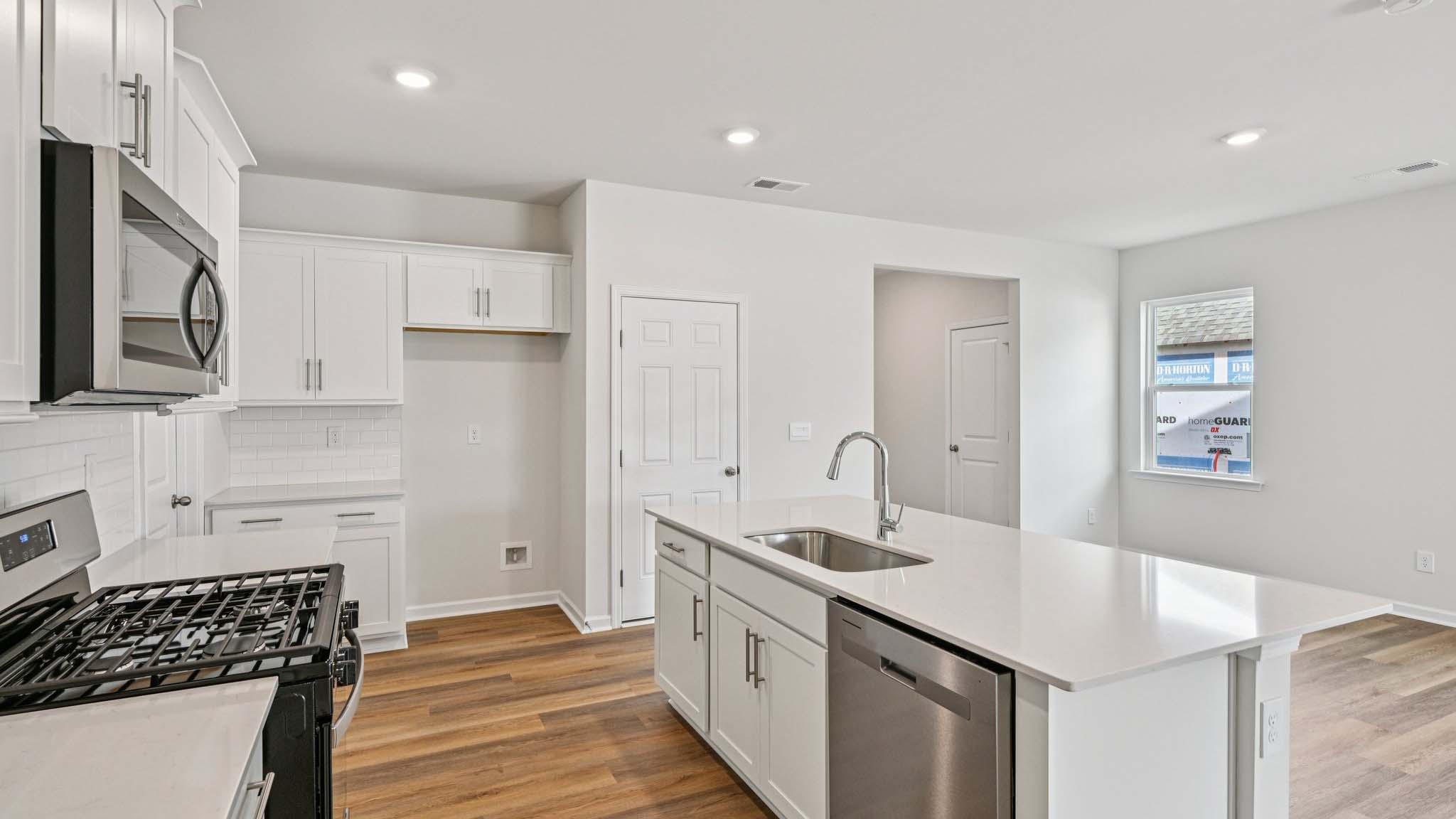 Kitchen and island with stainless steel appliances