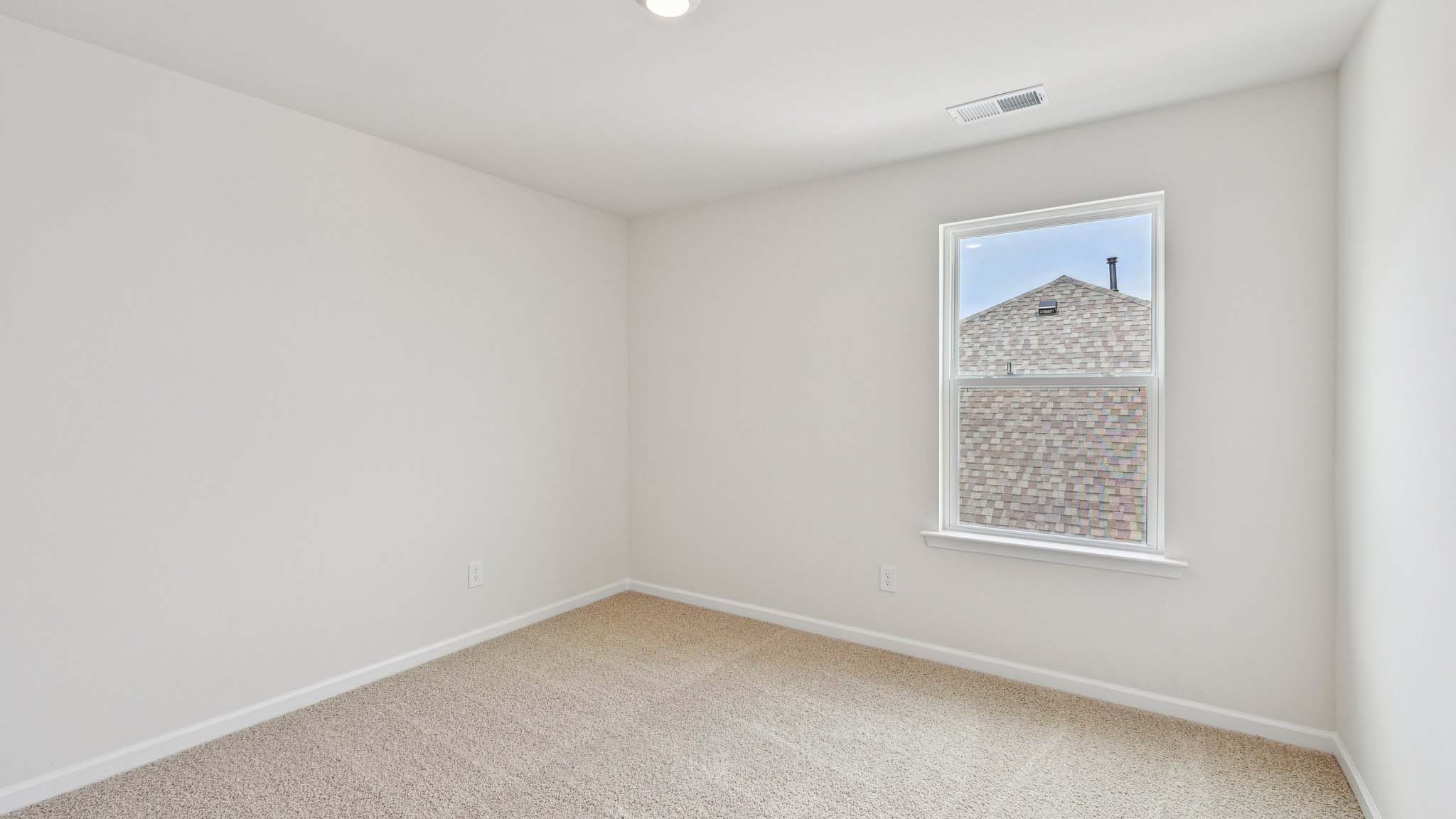 Carpeted bedroom with large window