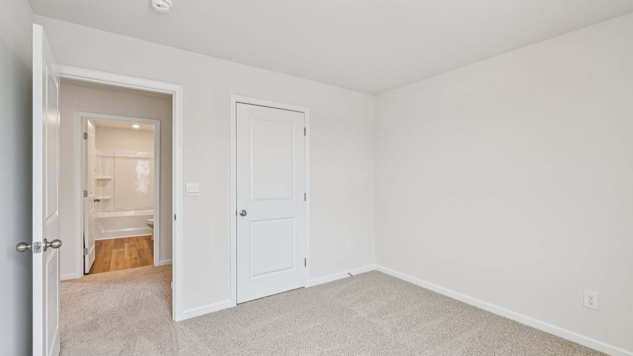 Carpeted bedroom with large window