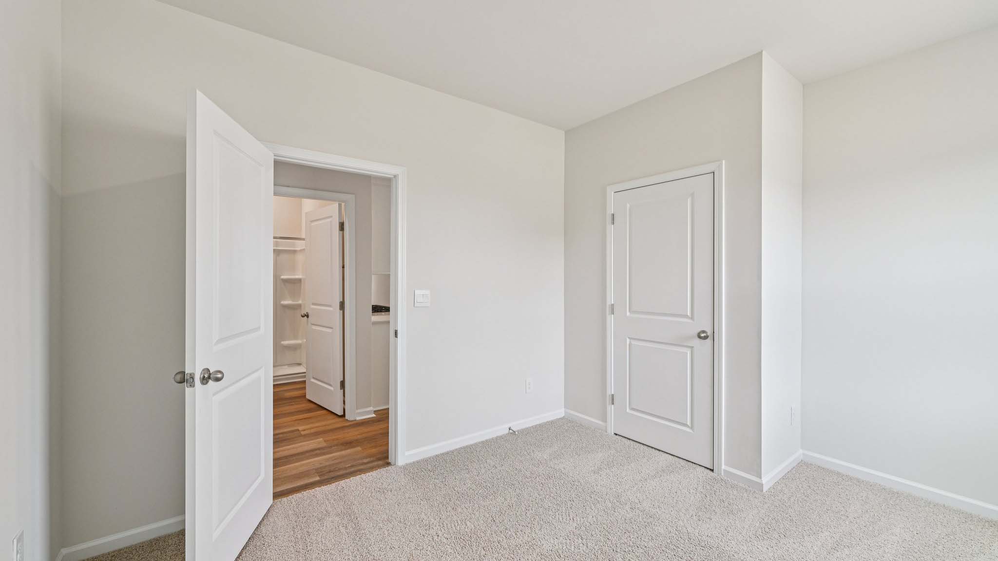 Carpeted bedroom with large window