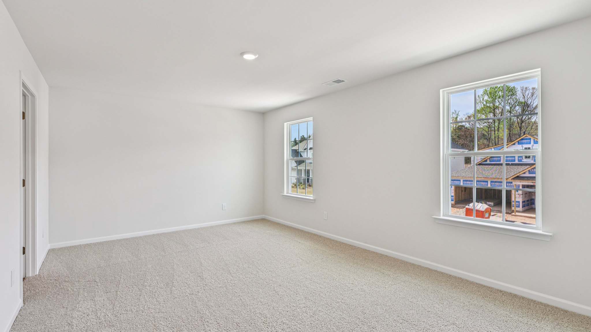 Carpeted bedroom with large window