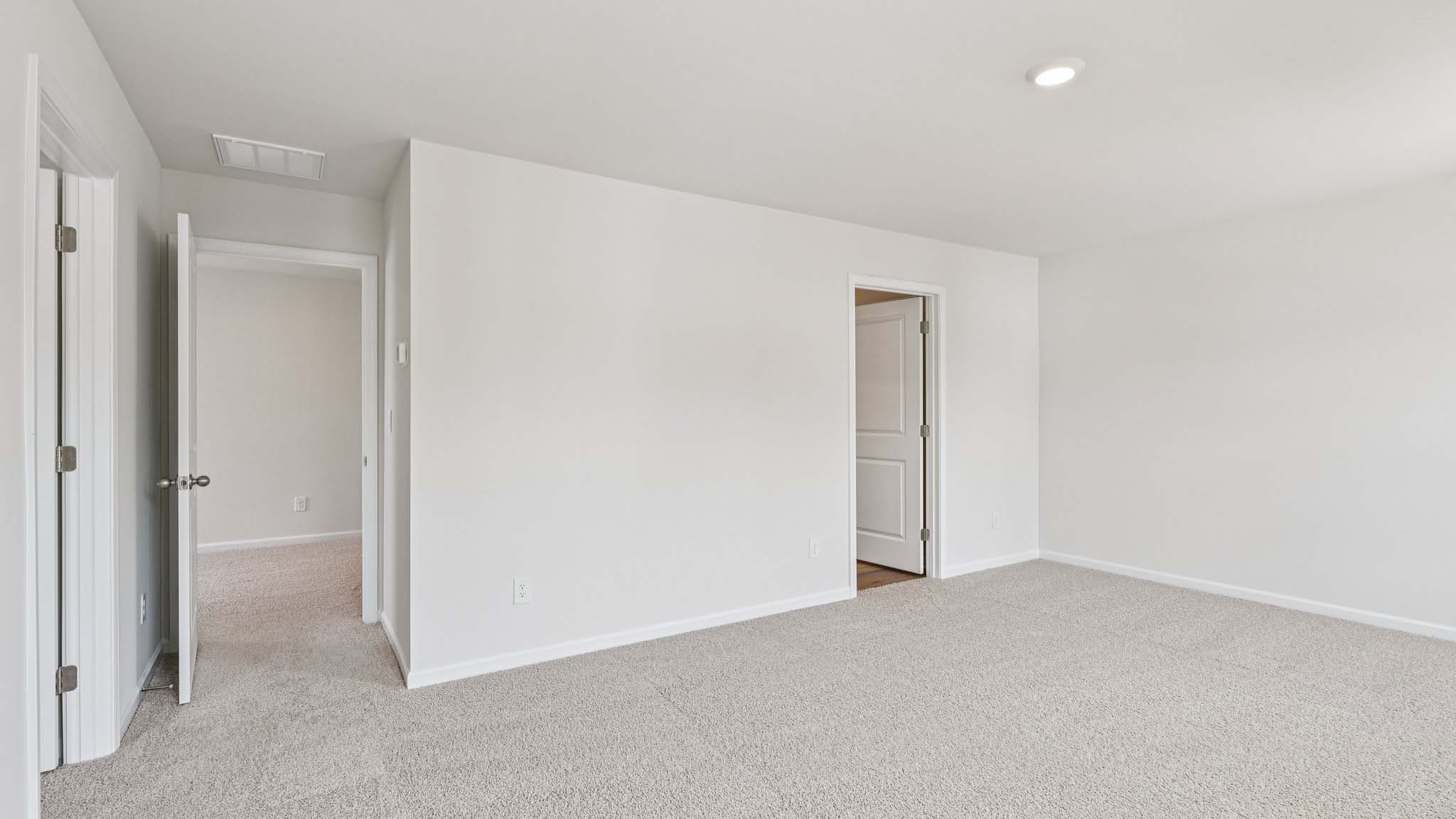 Carpeted bedroom with large window