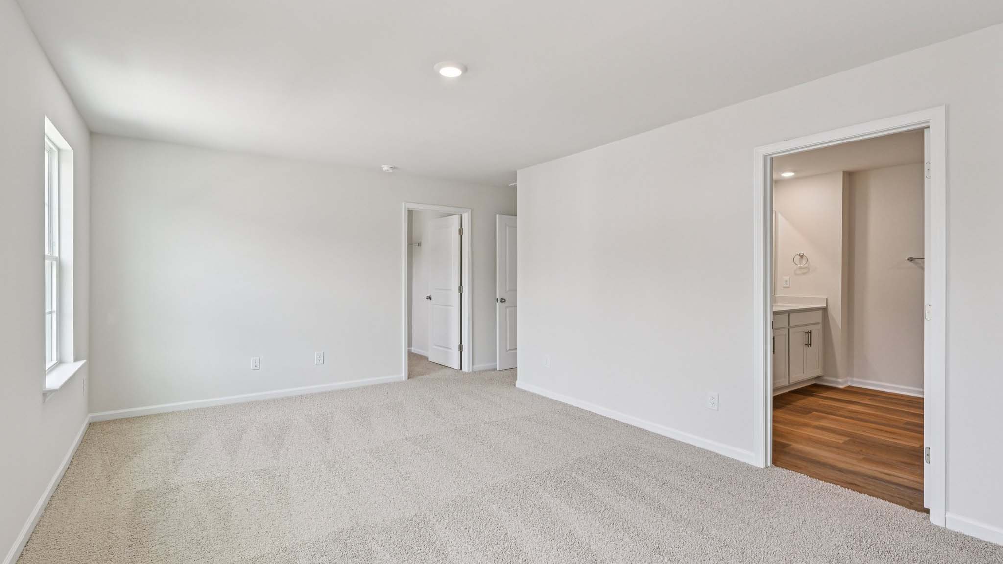 Carpeted bedroom with large window
