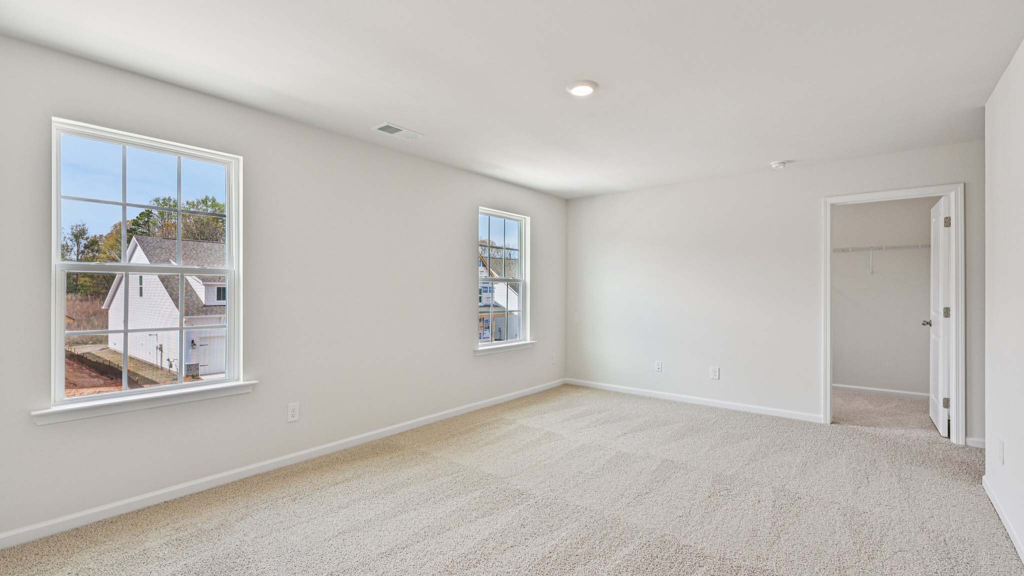 Carpeted bedroom with large window