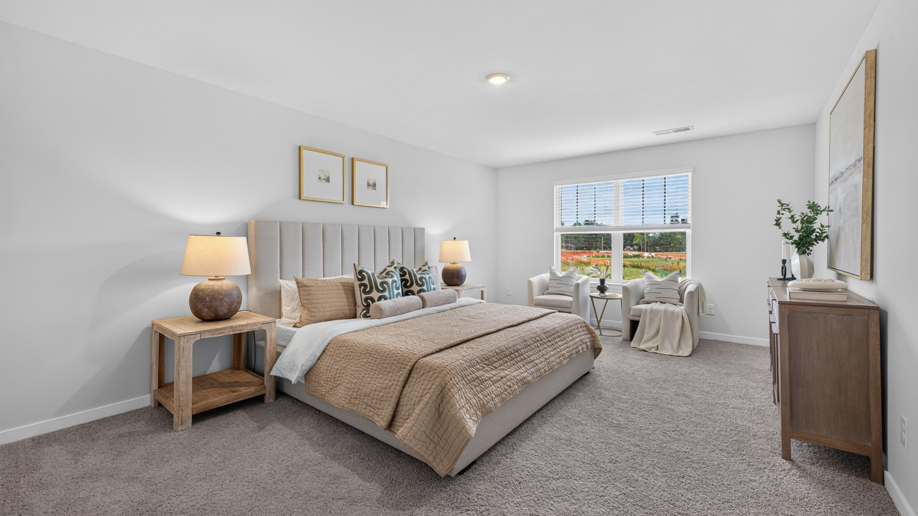 Primary carpeted bedroom with large windows