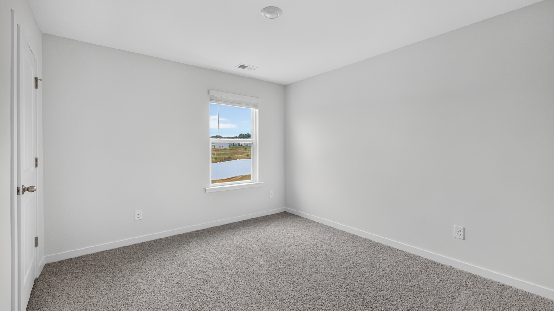Carpeted bedroom with windows