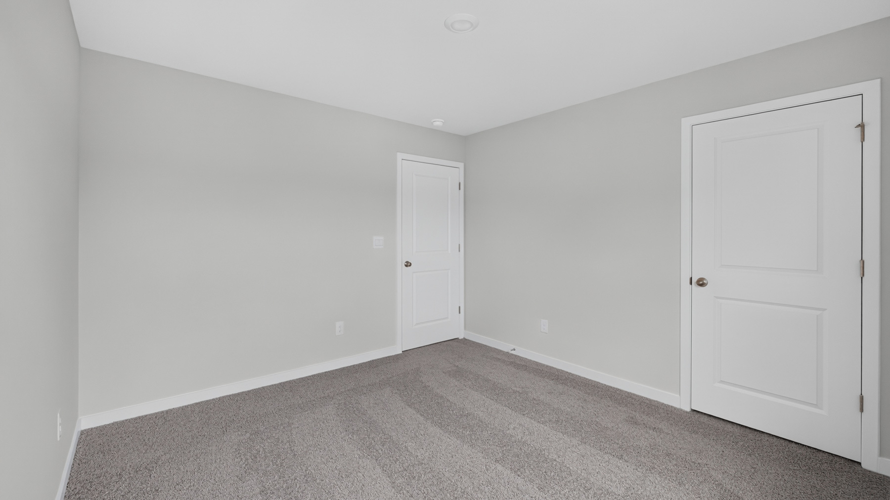 Carpeted bedroom with windows
