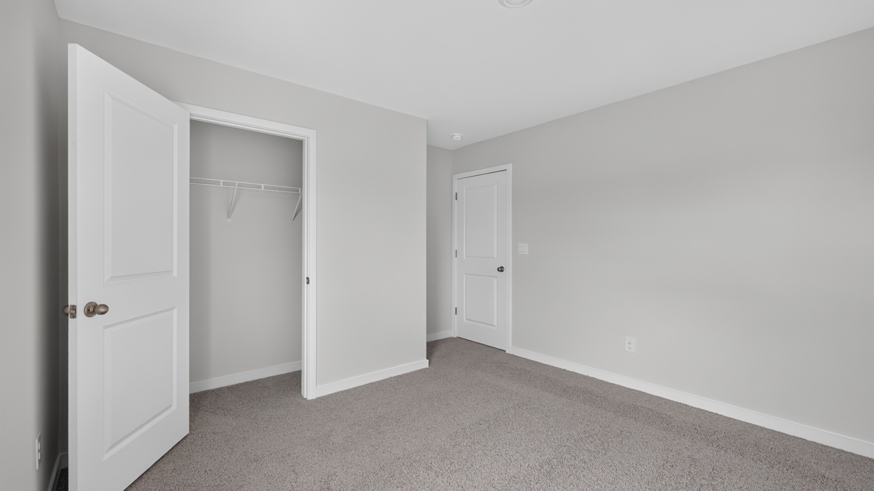 Carpeted bedroom with windows
