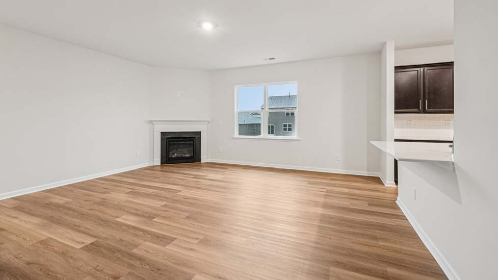 Open concept family room with fireplace and windows