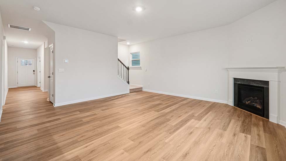 Open concept family room with fireplace and windows