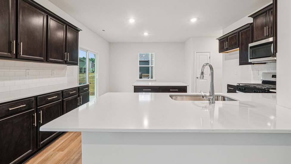 Kitchen and island with stainless steel appliances