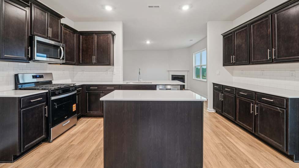 Kitchen and island with stainless steel appliances