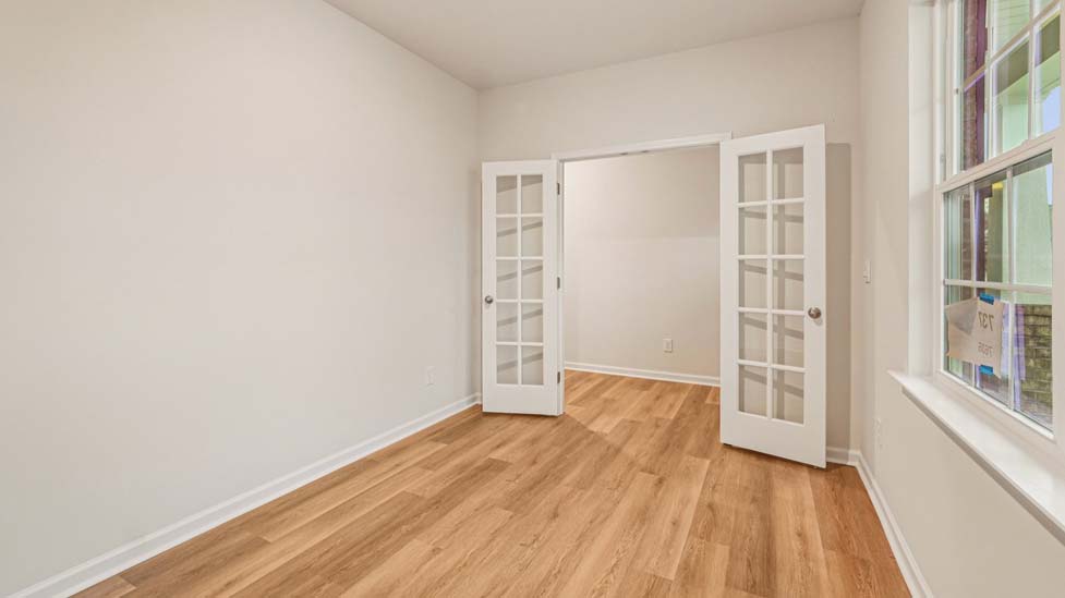 Hard wood floor flex room with windows