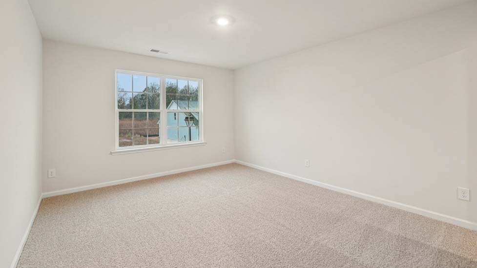 Carpeted bedroom with windows