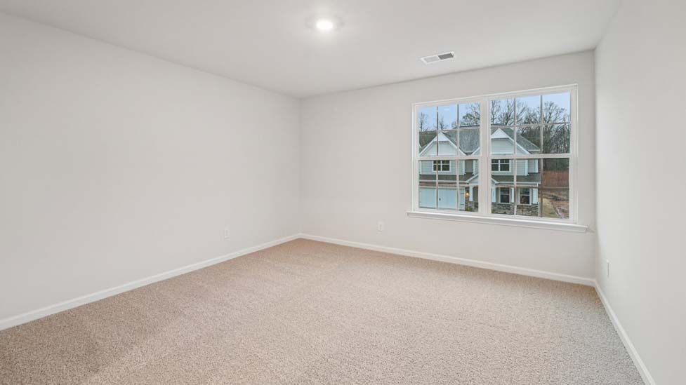 Carpeted bedroom with windows