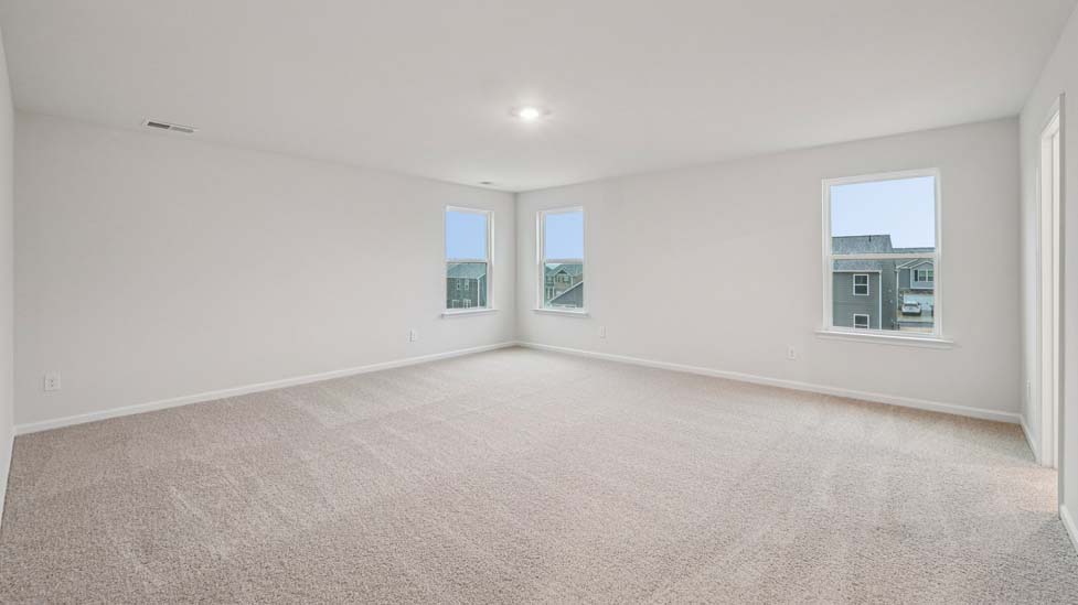 Carpeted Primary bedroom with windows