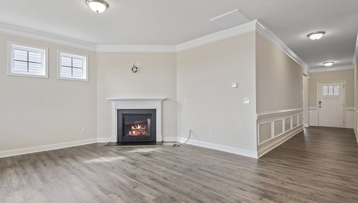 Living room space with large window and fireplace