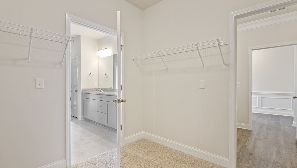Primary bedroom, carpeted floors, large windows